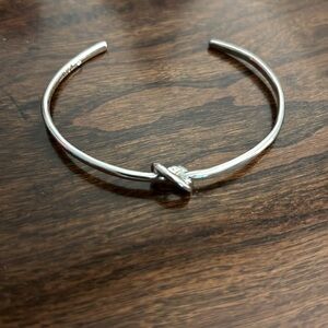 Silver wrist cuff with knot in middle. Adjustable!